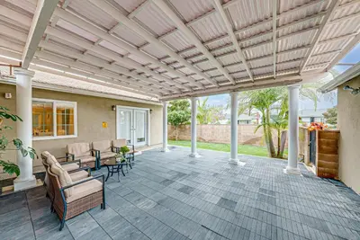an outdoor patio with a wooden ceiling and chairs at Entire 4BR 4BA House in West Covina Modern Private Comfortable in West Covina