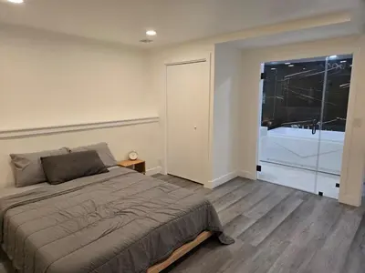 a bedroom with a bed and a large window at Soft elegance, modern guest house in Alhambra