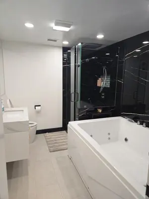 a bathroom with a tub and a shower and a toilet at Soft elegance, modern guest house in Alhambra