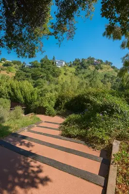 a walkway with bushes and trees on a hill at Coast Malibu 2BR Escape in Malibu