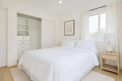 a white bedroom with a white bed and a window at Malibu Woods & Waves - 2 Bedroom in Malibu
