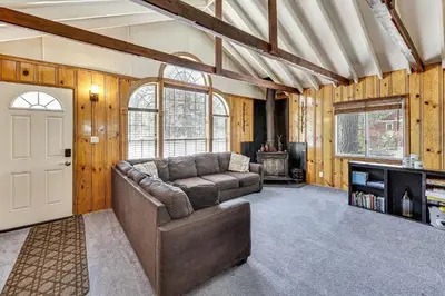 a living room with a couch and a door at Swim, Ski and Explore Cabin in Green Valley Lake! in Green Valley Lake