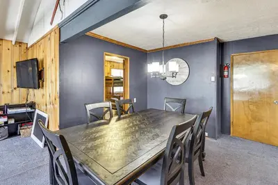a dining room with a wooden table and chairs at Swim, Ski and Explore Cabin in Green Valley Lake! in Green Valley Lake