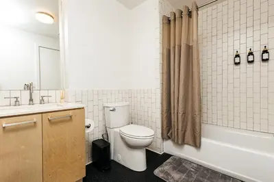 a bathroom with a toilet and a sink and a tub at Superior 2 bedroom apartment in Heart of Hollywood in Los Angeles