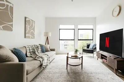 a living room with a couch and a tv at Superior 2 bedroom apartment in Heart of Hollywood in Los Angeles