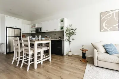 a kitchen and living room with a table and chairs at Superior 2 bedroom apartment in Heart of Hollywood in Los Angeles
