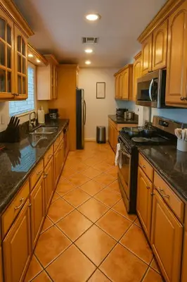 a kitchen with wooden cabinets and a tile floor at Stylish 3BR Getaway plus Pool in Tarzana