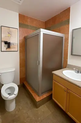 a bathroom with a toilet and a shower and a sink at Modern Comfort near Universal in Los Angeles