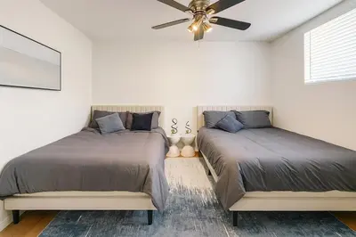 a bedroom with two beds and a ceiling fan at Modern Comfort near Universal in Los Angeles