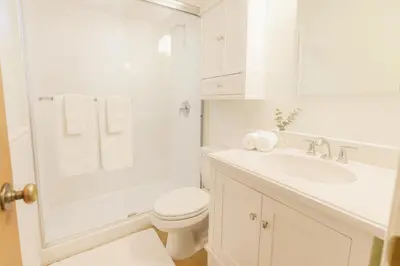 a white bathroom with a toilet and a sink at Fullerton Fairytale Vacation Home - 10 Min Drive to Disneyland in Fullerton