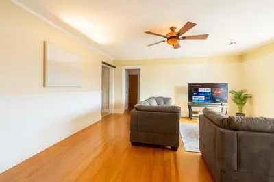 a living room with a couch and a ceiling fan at Fullerton Fairytale Vacation Home - 10 Min Drive to Disneyland in Fullerton