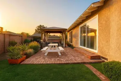 a picnic table on a brick patio with a gazebo at Fullerton Fairytale Vacation Home - 10 Min Drive to Disneyland in Fullerton
