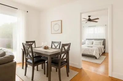 a dining room with a table and chairs and a bed at Fullerton Disneyland Getaway - 4BR in Fullerton