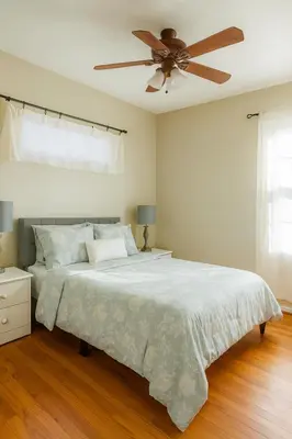 a bedroom with a bed with a ceiling fan at Fullerton Adventure Basecamp - Short Trip To Disneyland in Anaheim
