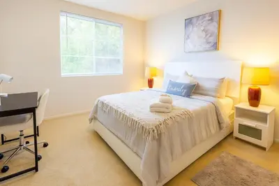 a bedroom with a bed with a desk and a window at Marina del Rey Coastal 2BR Retreat- Pool, Hot Tub, Gym in Los Angeles