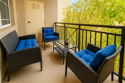 a porch with two chairs and a table and chairs gmaxwell gmaxwell gmaxwell at Marina del Rey Coastal 2BR Retreat- Pool, Hot Tub, Gym in Los Angeles