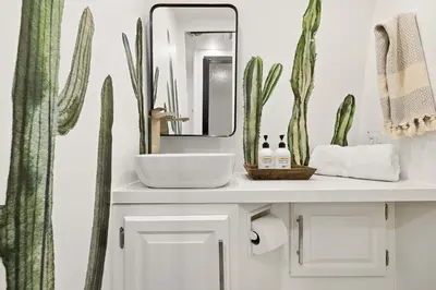 a bathroom with a sink and a mirror and cactus at Hip Venice Beach Luxury Airstream & Creative Space in Los Angeles