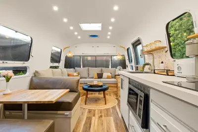 a kitchen and living room of an rv at Hip Venice Beach Luxury Airstream & Creative Space in Los Angeles