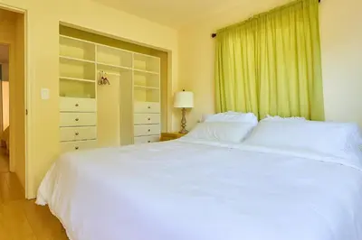 a bedroom with a large white bed and a window at Malibu Beach - Nature 2BR Retreat in Malibu