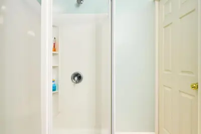 a shower with a glass door next to a bathroom at Malibu 2BR In Woods Close To Beach in Malibu