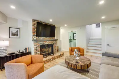 a living room with a fireplace and a tv at Stunning Forest Views Luxury Lake Arrowhead Cabin in Lake Arrowhead