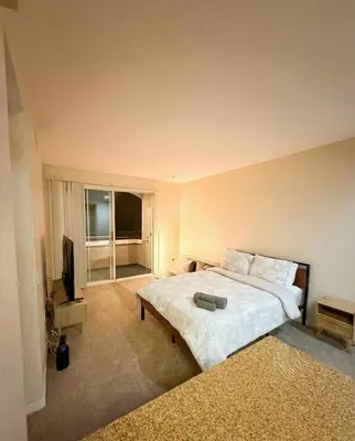 a bedroom with a large bed and a flat screen tv at Marina Del Rey Luxe 2-Bedroom & 1-Bedroom - Hot Tub, Pool Table, Grill & Cinema Projector in Marina del Rey