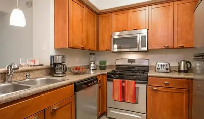 a kitchen with a sink and a stove and microwave at Marina Del Rey Luxe 2-Bedroom & 1-Bedroom - Hot Tub, Pool Table, Grill & Cinema Projector in Marina del Rey