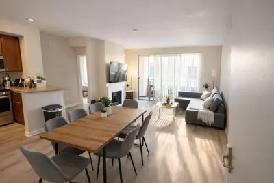 a living room with a table and chairs and a couch at Sunny Marina Del Rey Apartment- Hot Tub, Game Room, BBQ, Projector in Los Angeles