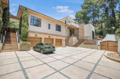 a car parked in a driveway in front of a house at Bowmont in Los Angeles
