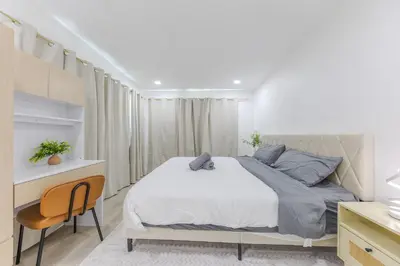 a bedroom with a bed and a desk and a chair at Cozy & Brand New 3BR Home in West Covina in West Covina