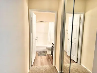 a bathroom with a toilet and a mirror at Cozy and Stylish Unit CC 107 in Los Angeles