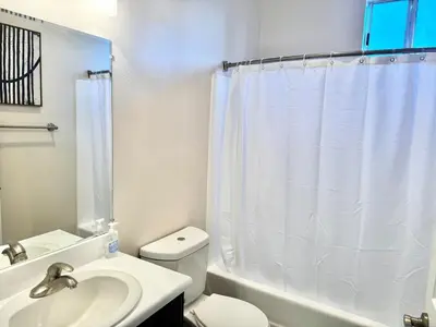 a bathroom with a white toilet and a sink at Cozy and Stylish Unit CC 107 in Los Angeles