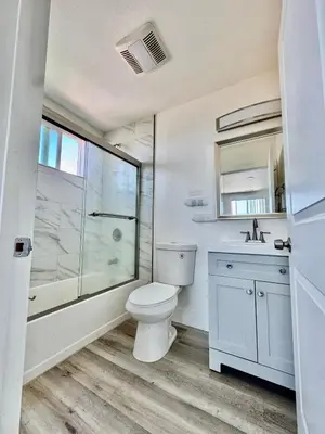 a bathroom with a toilet and a shower and a sink at The Ostel in Los Angeles