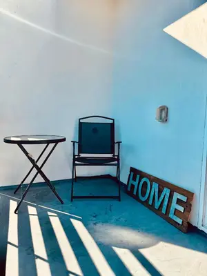 a chair sitting in a room with a table at The Ostel in Los Angeles