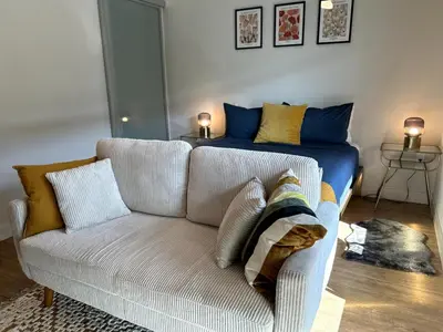 a living room with a couch and a bed at Cozy studio in heart of Santa Monica free parking in Los Angeles