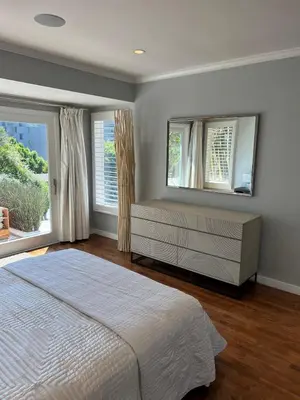 a bedroom with a bed and two windows at Sunset Strip 5 Star Location w Pool Jacuzzi Cabana BBQ in Los Angeles
