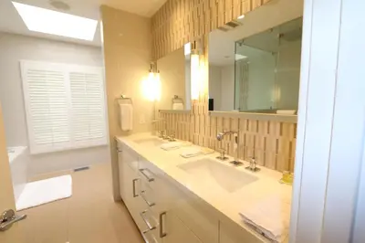 a bathroom with a sink and a large mirror at Sunset Strip 5 Star Location w Pool Jacuzzi Cabana BBQ in Los Angeles