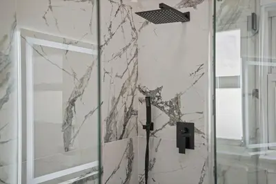 a shower with a glass door in a bathroom at Stylish Cozy getaway in West Valley Area Heliport