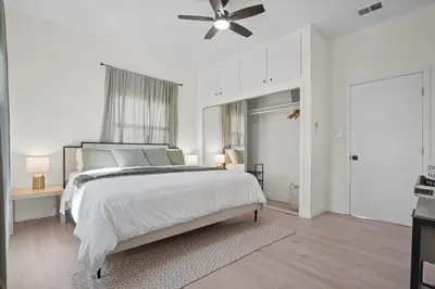 a white bedroom with a bed and a ceiling fan at Stylish Cozy getaway in West Valley Area Heliport