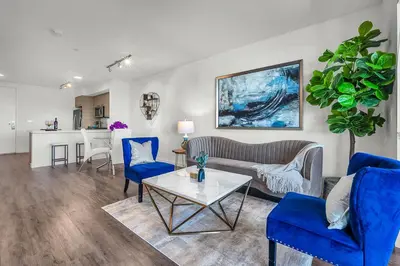 a living room with a couch and chairs and a table at Luxury by the Beach with Pool, Gym, Game Room in Los Angeles