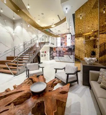 a living room with a large wooden table and chairs at Luxury by the Beach with Pool, Gym, Game Room in Los Angeles