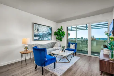 a living room with a couch and two blue chairs at Luxury by the Beach with Pool, Gym, Game Room in Los Angeles