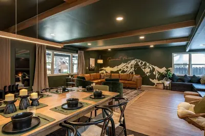 a living room with a table and a couch at Summit Haven: Game Room | Sauna | Spa | 1/4 Acre in Big Bear Lake