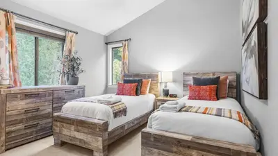 a bedroom with two beds and a window at 5BDR Stay w Fireplace Game room Family-Friendly Amenities Arrowhead Chalet by AvantStay in Lake Arrowhead