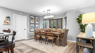 a dining room and living room with a table and chairs at 5BDR Stay w Fireplace Game room Family-Friendly Amenities Arrowhead Chalet by AvantStay in Lake Arrowhead