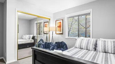 a bedroom with a bed and a mirror at 5BDR Stay w Fireplace Game room Family-Friendly Amenities Arrowhead Chalet by AvantStay in Lake Arrowhead