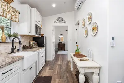 a kitchen with white cabinets and a sink at The Petite-Villas at Dorner Family Vineyard in Tehachapi