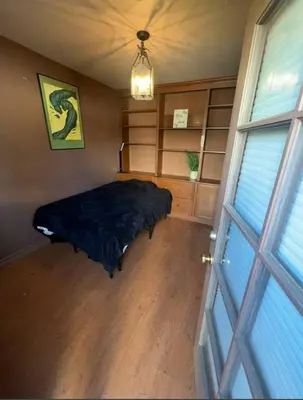 a bedroom with a bed and a large window at Private room in guest house - Mini Mansion in Burbank