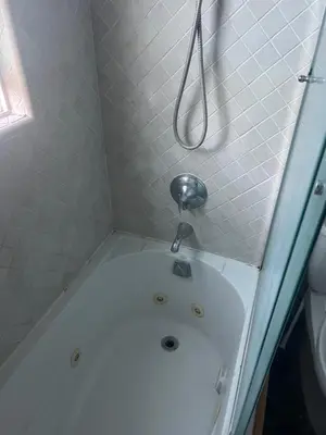 a bathroom with a bath tub with a shower at Private room in guest house - Mini Mansion in Burbank