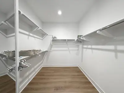 a walk in closet with white walls and white shelves at #Marbella Lane - Spacious 4BR Modern Family Home! in Placentia
